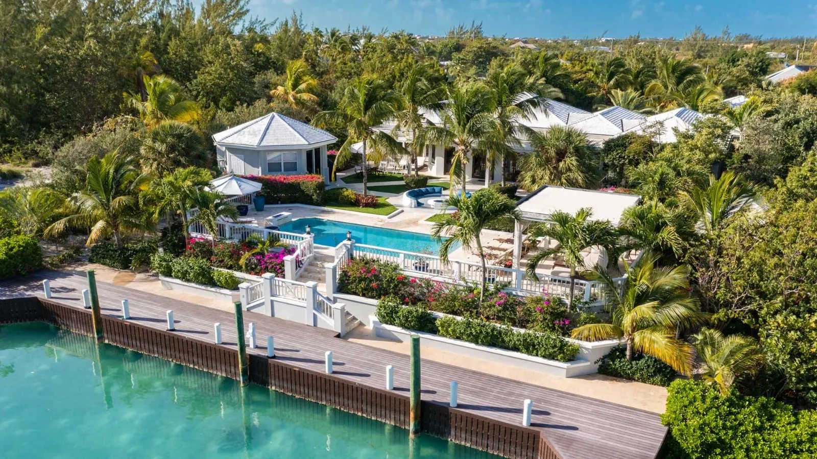 Aerial of the Turks and Caicos villa and its private dock on the turquoise canal.
