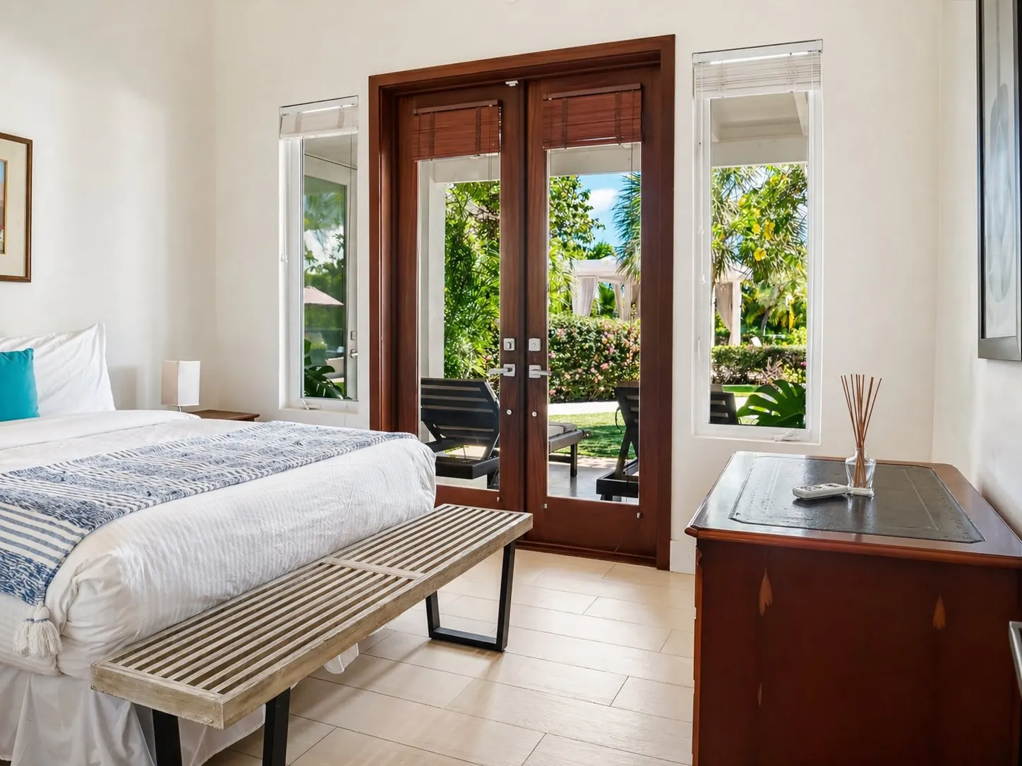 Bedroom Four, queen bed in a bright room with morning light.